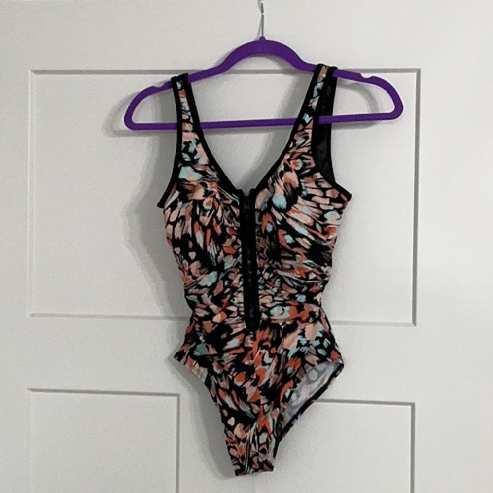 Beautiful one piece swimsuit and swim skirt combo.  Size women’s 10.